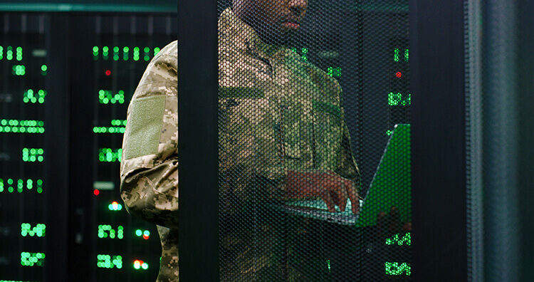 photograph of military personal working in secure server room